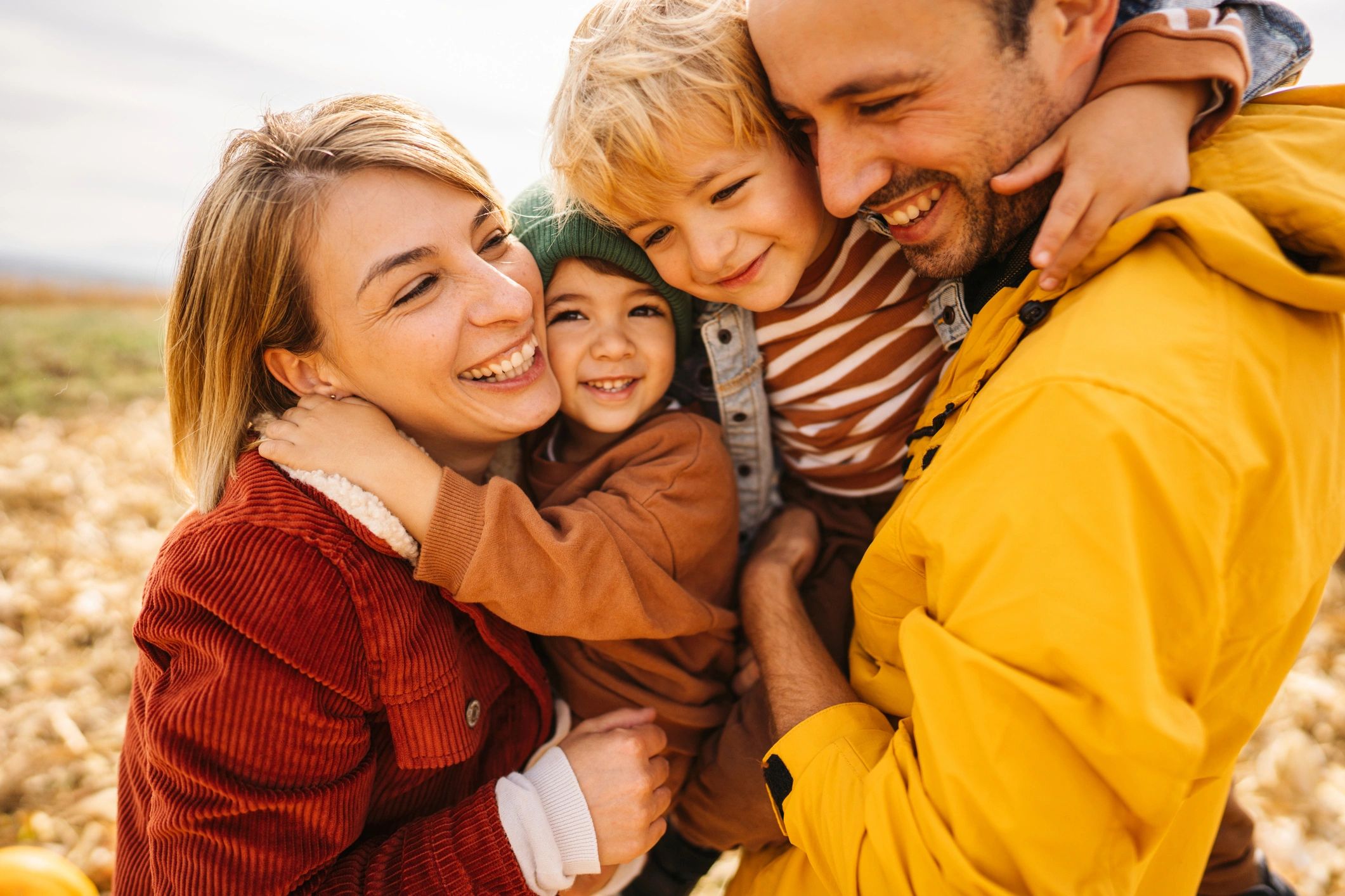 Young family smiling on an agricultural field