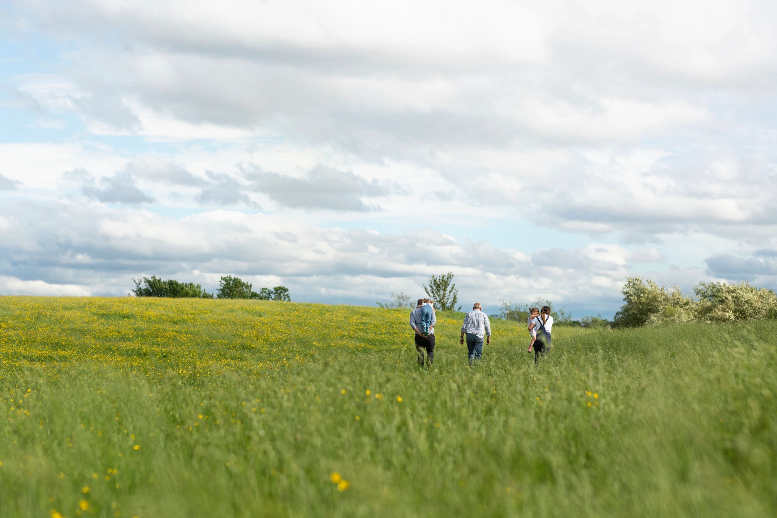 Family walking together on a farm path