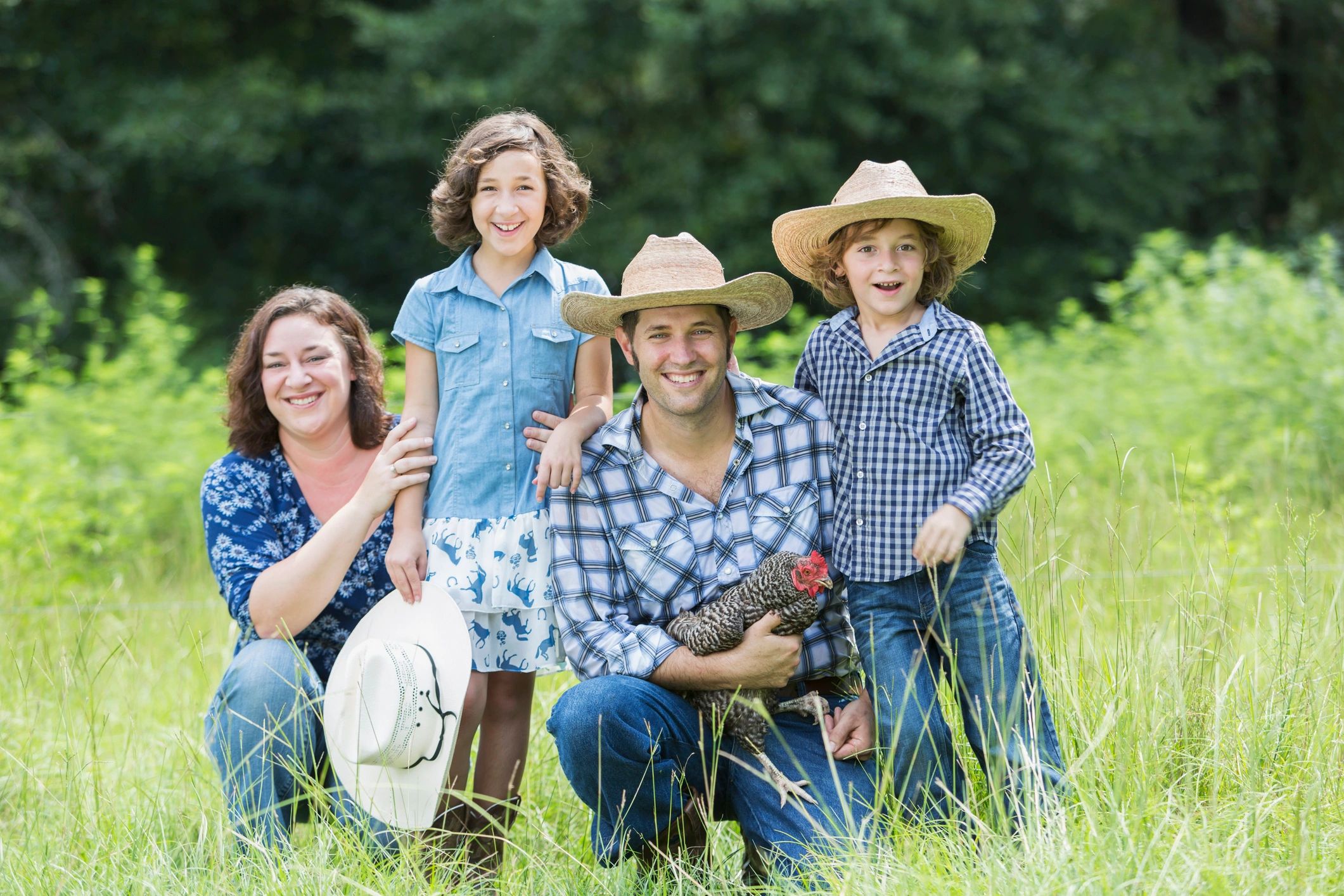 Family on a farm, smiling outdoors