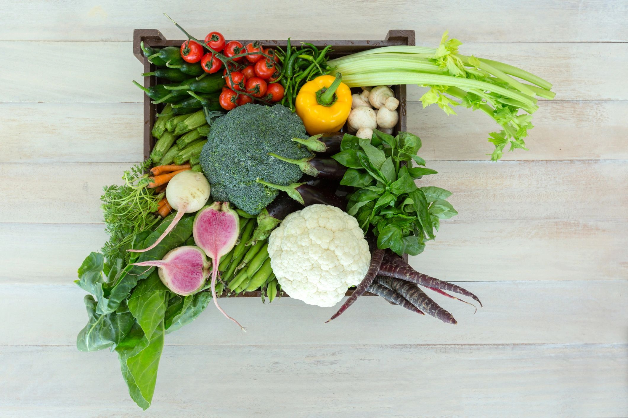 Wooden crate packed with fresh vegetables